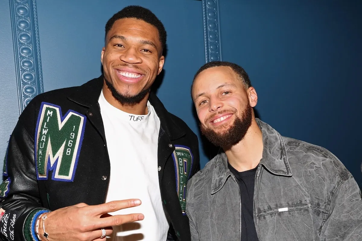 NBA stars Giannis Antetokounmpo and Stephen Curry smile together at a party