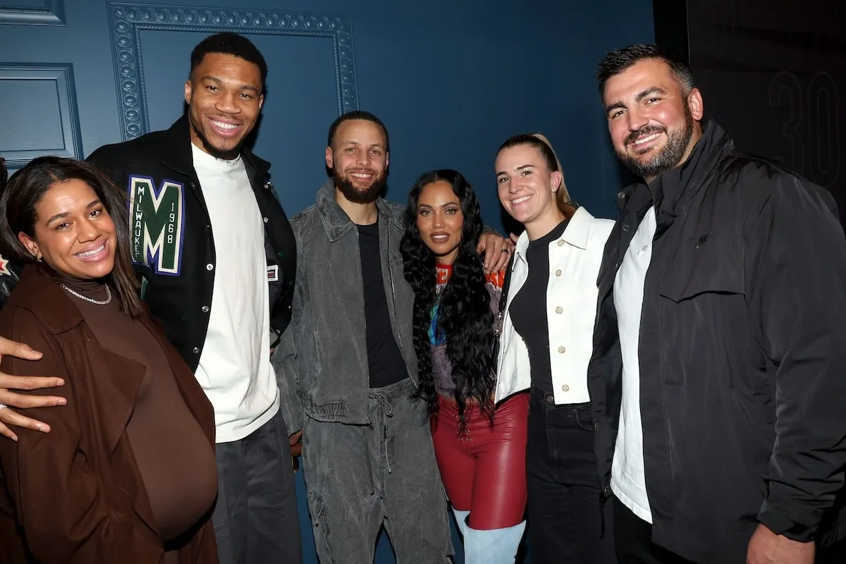 Celebrities Mariah Riddlesprigger, Giannis Antetokounmpo, Stephen Curry, Ayesha Curry, Sabrina Ionescu, and Hroniss Grasu take a photo together at Stephen Curry's bourbon party