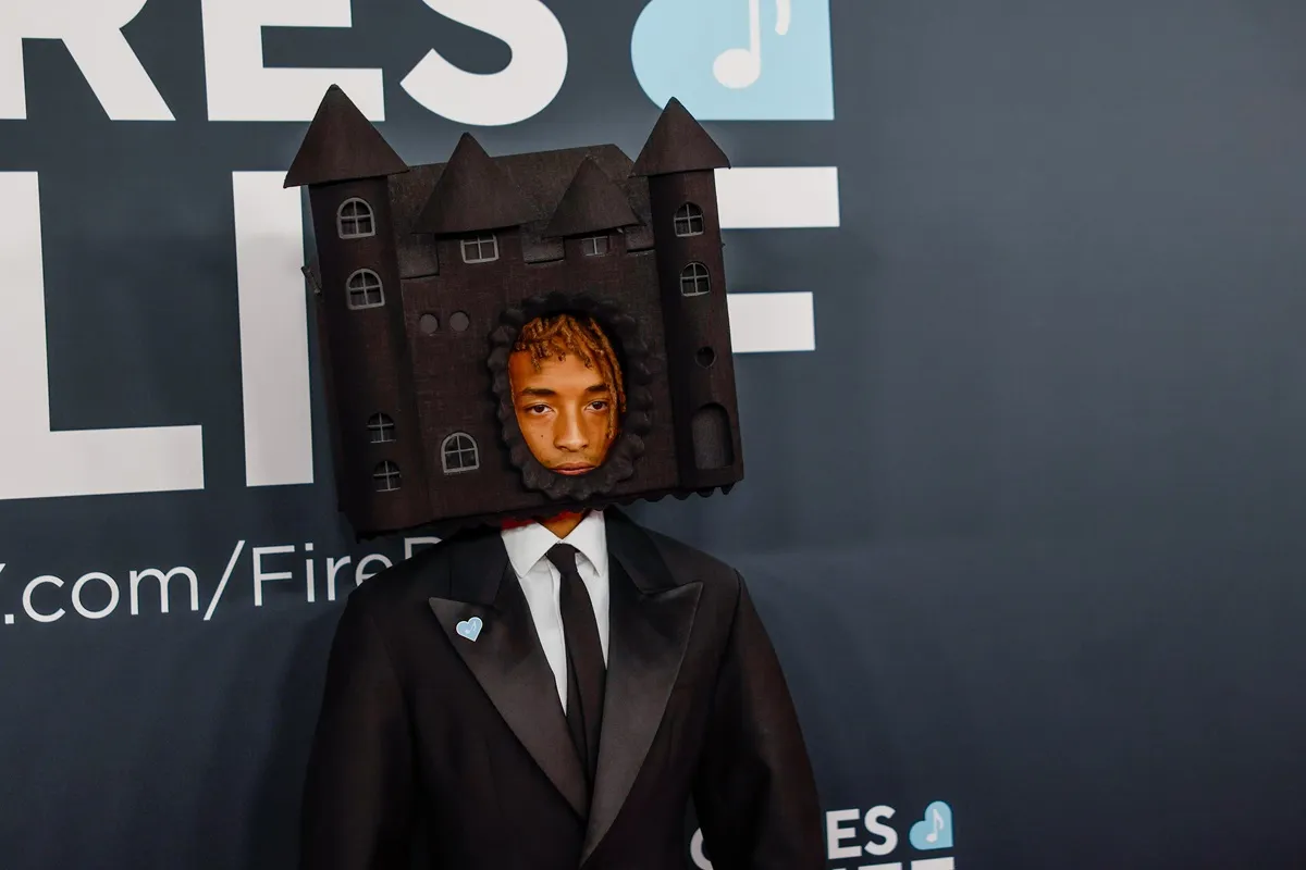 Jaden Smith posing at the Grammys wearing a suit and house on his head.