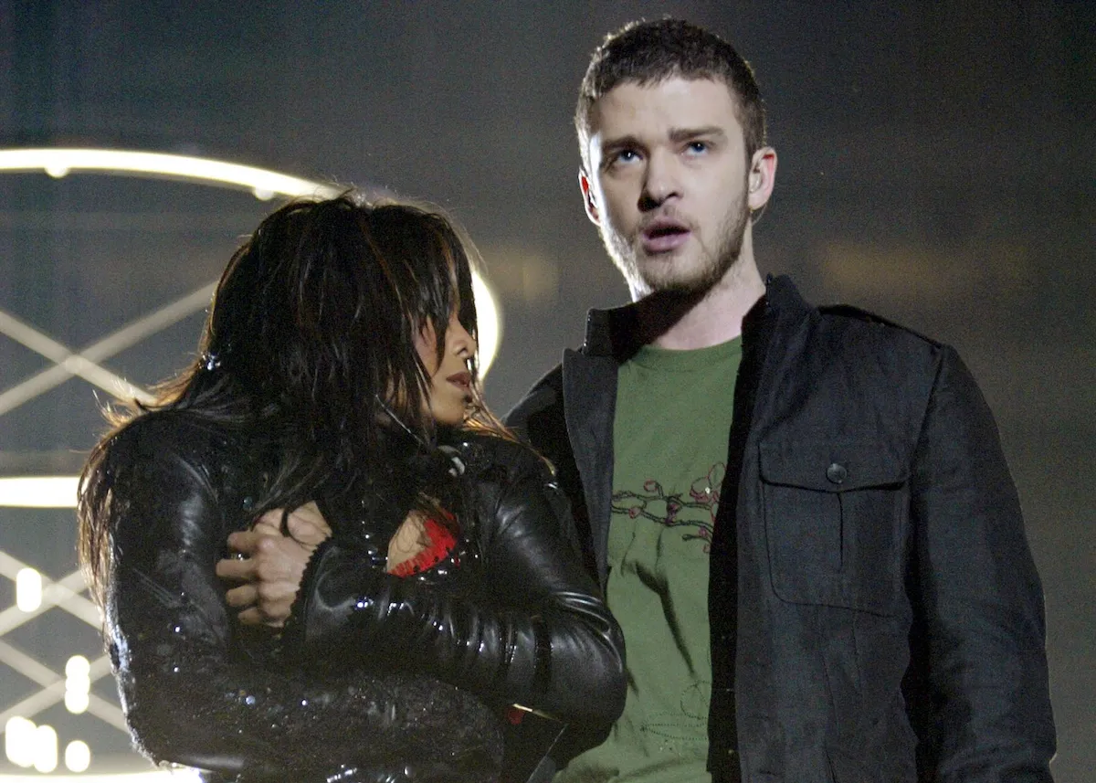 Janet Jackson covers her breast at the Super Bowl while standing next to a stunned Justin Timberlake