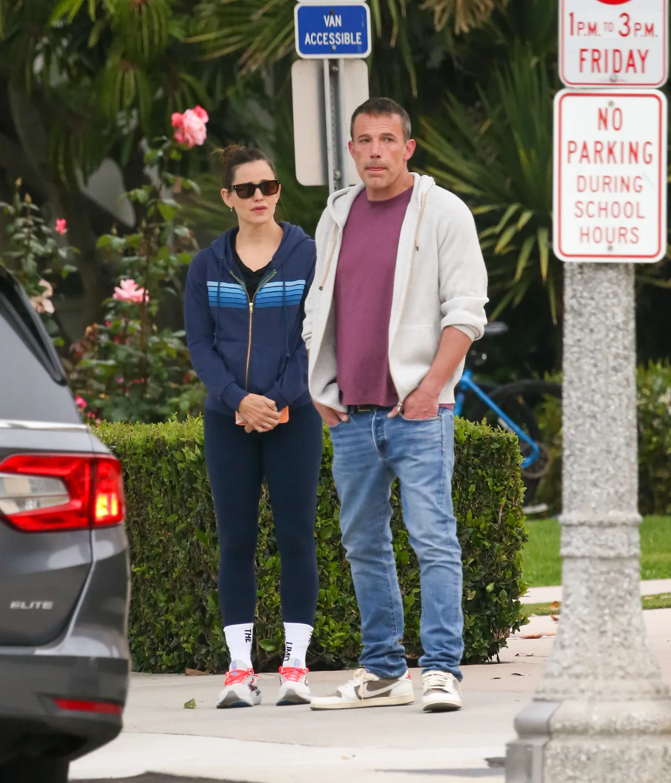 Jennifer Garner in a striped zip-up hoodie standing next to Ben Affleck, who's in a sweatshirt and jeans, in LA