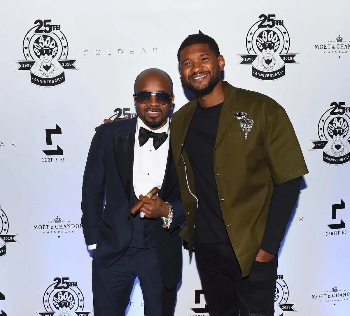 Usher smiles with Jermaine Dupri and Usher as they smoke cigars at a party in 2018