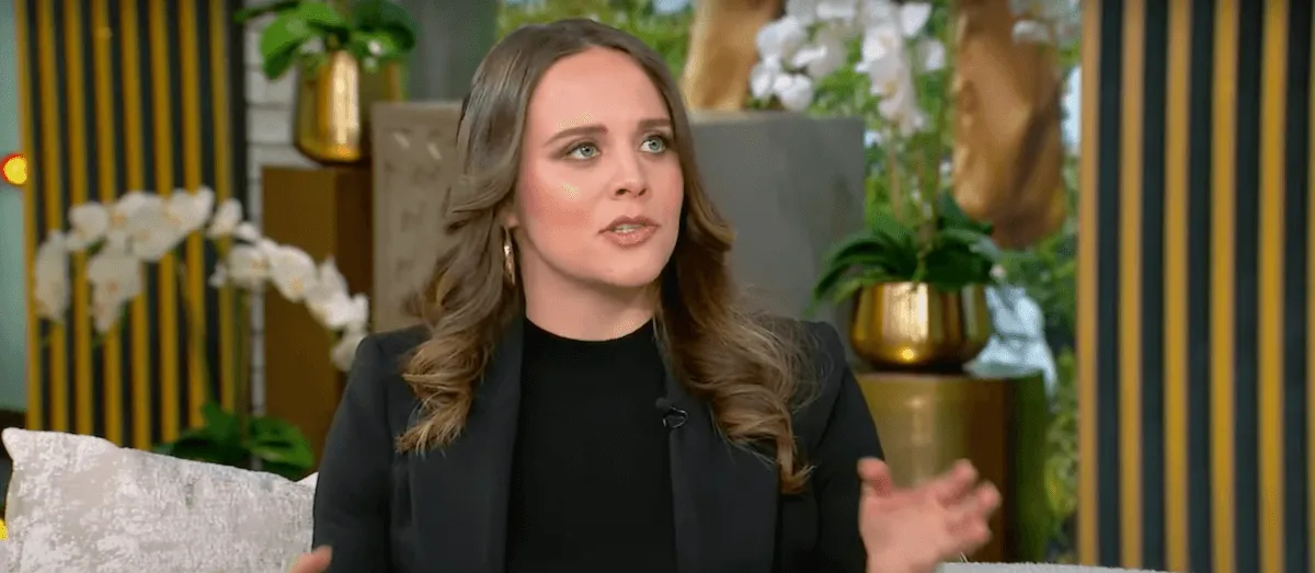 Jinger Duggar, wearing a black top and black blazer, on the Tamron Hall Show