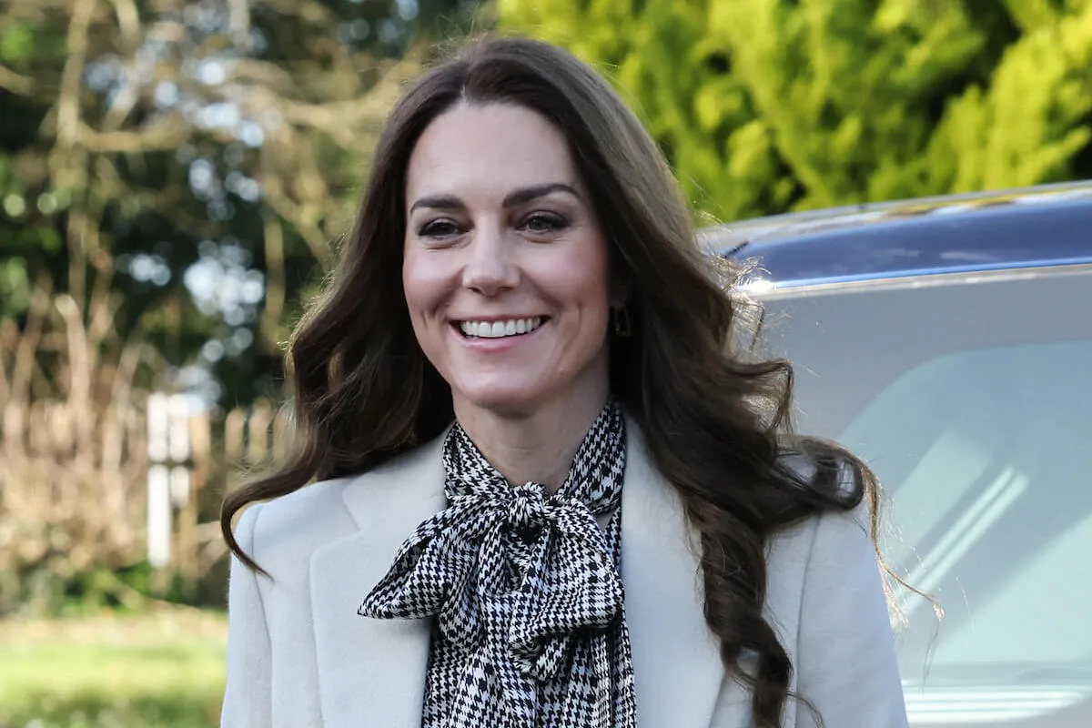 Kate Middleton, who doesn't wan to talk about her clothes publicly, smiles and looks on