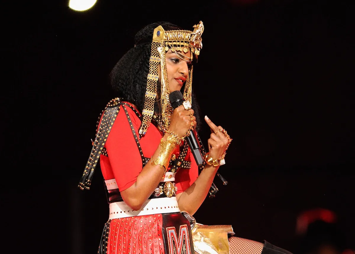 M.I.A., wearing an elaborate headdress, gives the middle finger during the Super Bowl Halftime Show