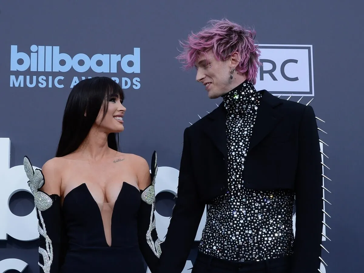 Megan Fox and Machine Gun Kelly attend the 2022 Billboard Music Awards in matching outfits.