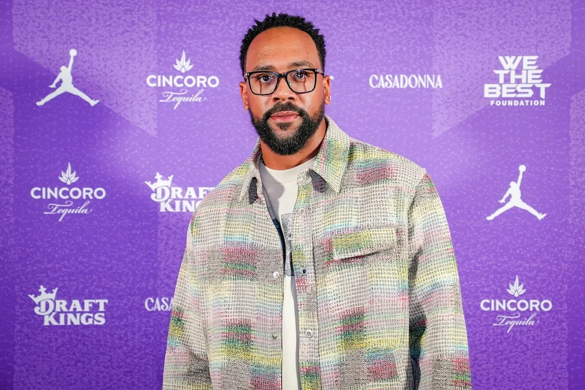 Wearing a plaid shirt, Marcus Jordan smiles for cameras at DJ Khaled's 2024 golf tournament