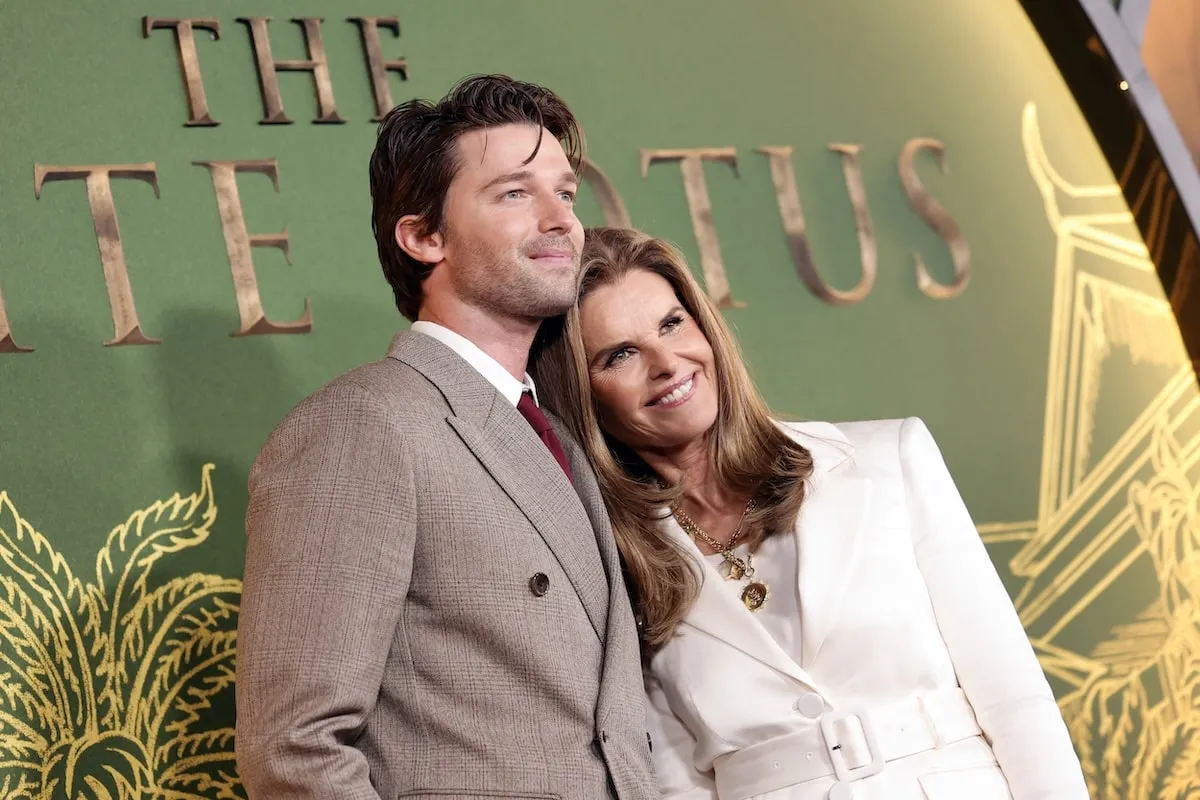 Actor Patrick Schwarzenegger smiles with his mom Maria Shriver on the red carpet