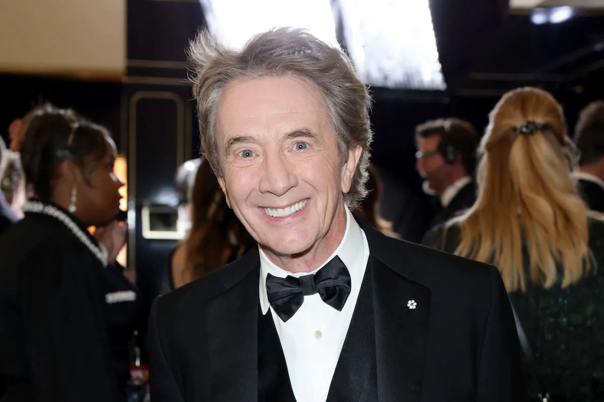 Martin Short, who wasn't at the 2025 SAG Awards when he won, smiles wearing a tuxedo.