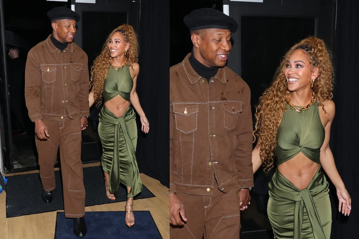 Wearing a green dress with a stomach cutout, Meagan Good shows off her toned tummy with Jonathan Majors