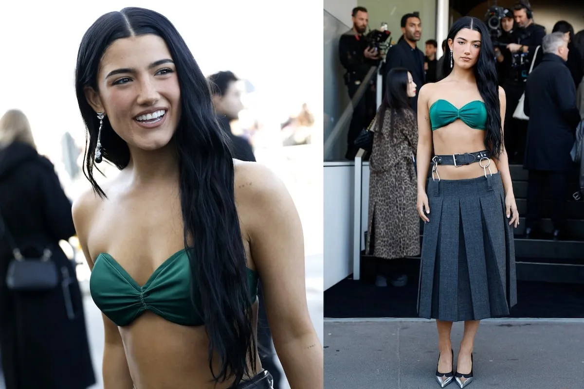 Wearing a green bralette and pleated skirt, Charli D'Amelio smiles at paparazzi after the Milan Fashion Week Womenswear Fall/Winter 2025/26