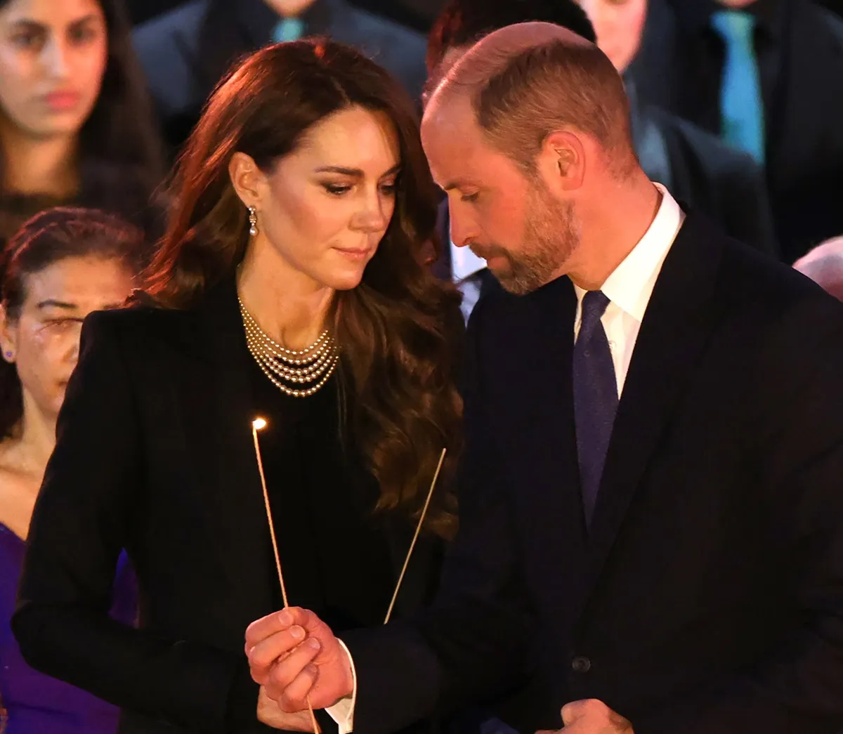 Prince William and Kate Middleton light candles during a ceremony commemorating Holocaust Memorial Day in London