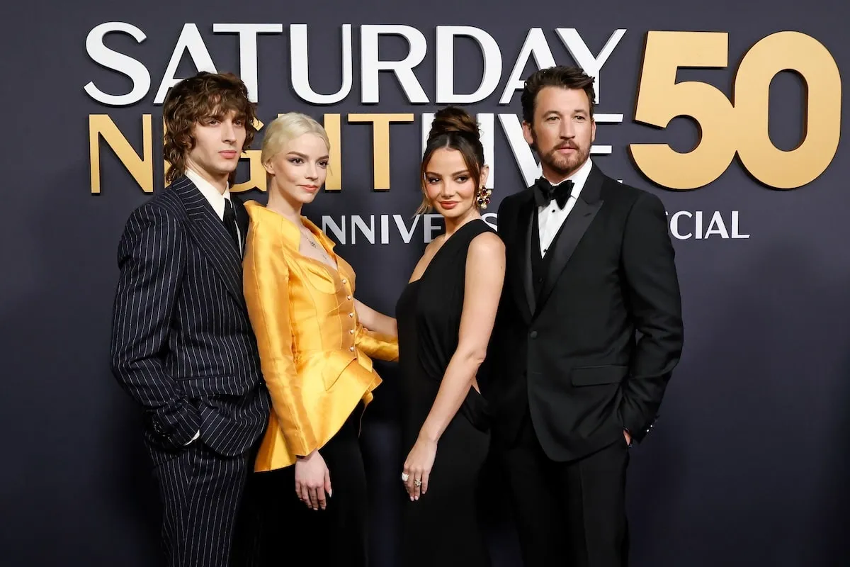 Wearing formalwear, Malcolm McRae, Anya Taylor-Joy, Keleigh Sperry Teller, and Miles Teller pose together on the red carpet before 'SNL50'