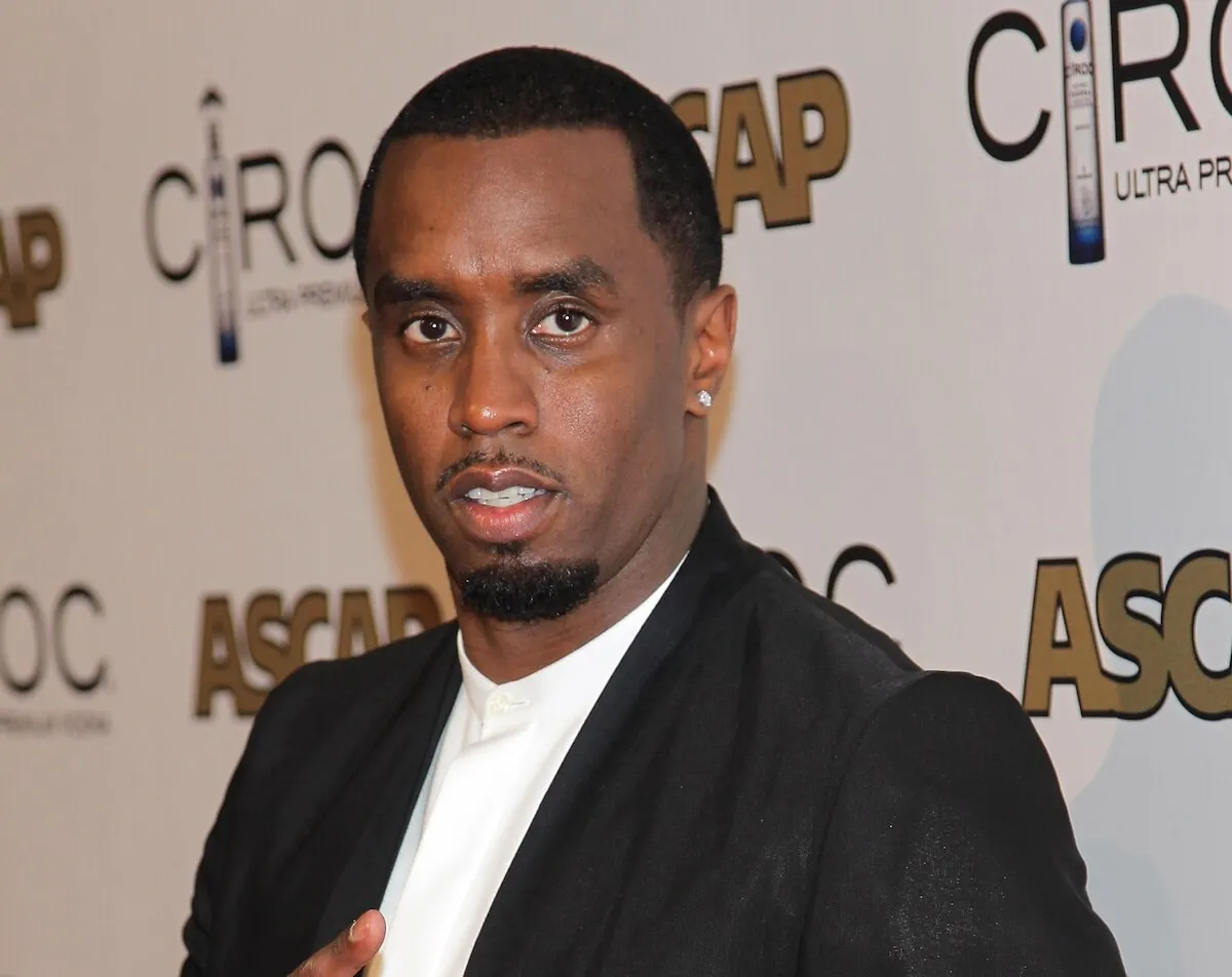 Sean 'Diddy' Combs wears a white shirt with a black suit jacket.