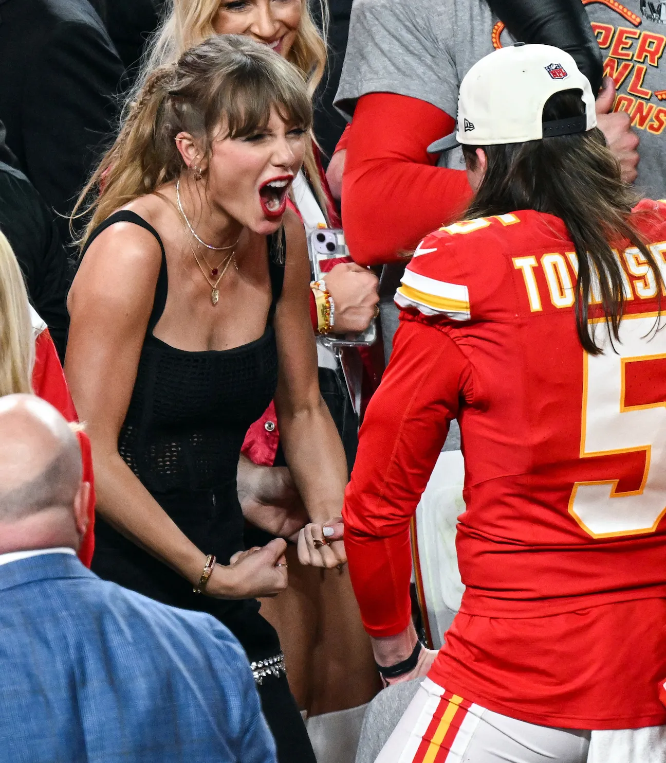 Taylor Swift making a muscle pose with Tommy Townsend from the Kansas City Chiefs after 2024 Super Bowl 