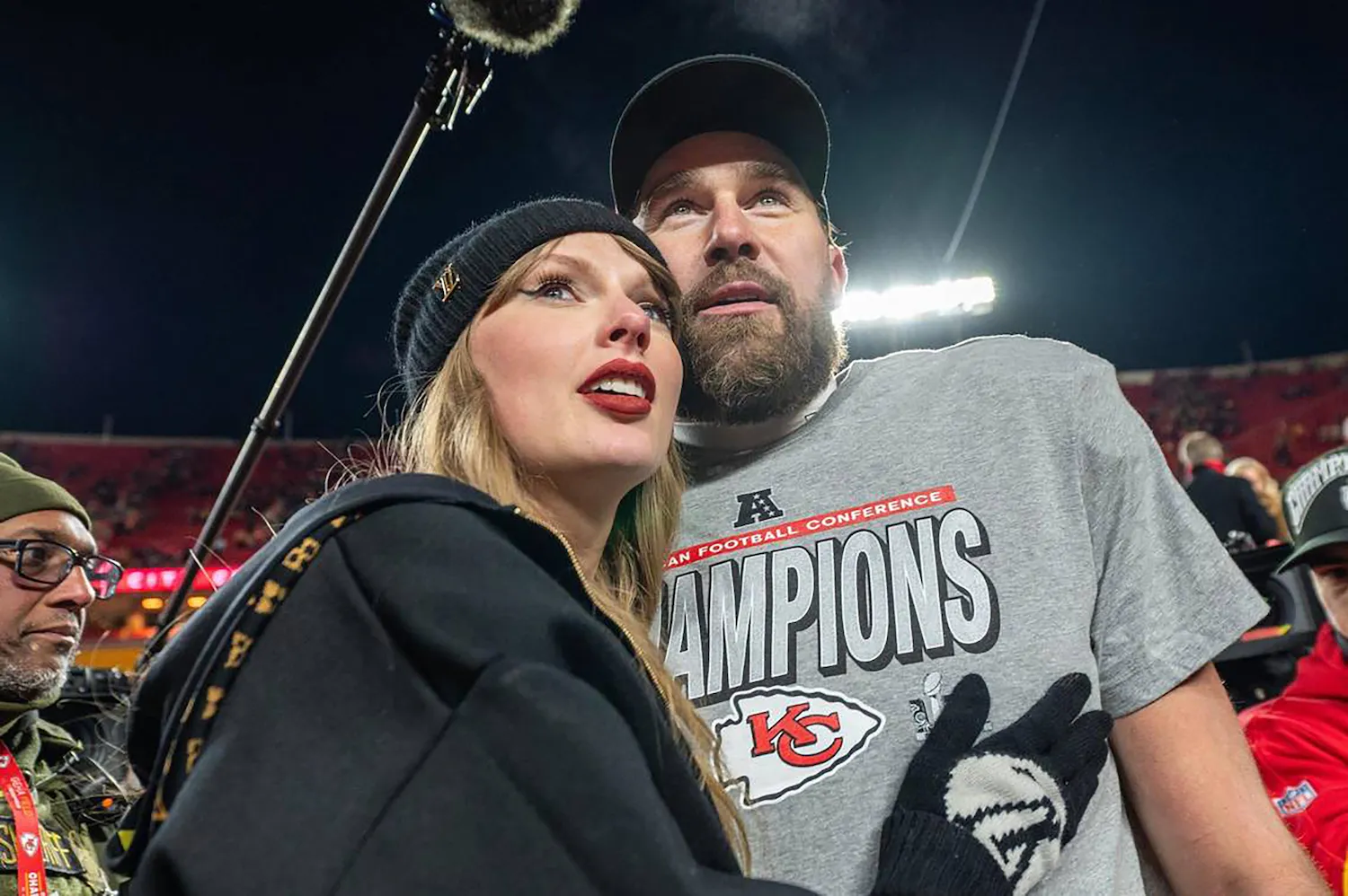 Taylor Swift and Travis Kelce embracing and looking up after Kansas City Chiefs game