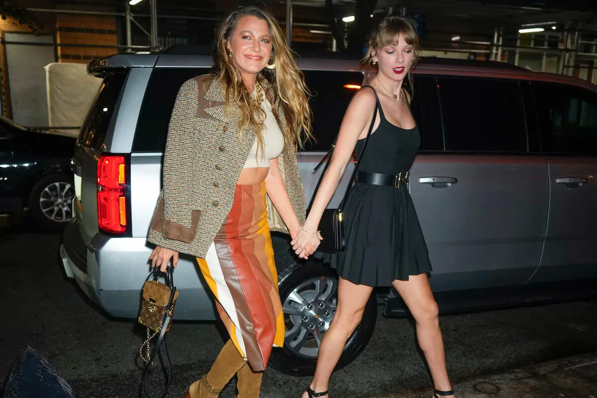 Taylor Swift and Blake Lively, who has reportedly inspired Swift's next album, hold hands