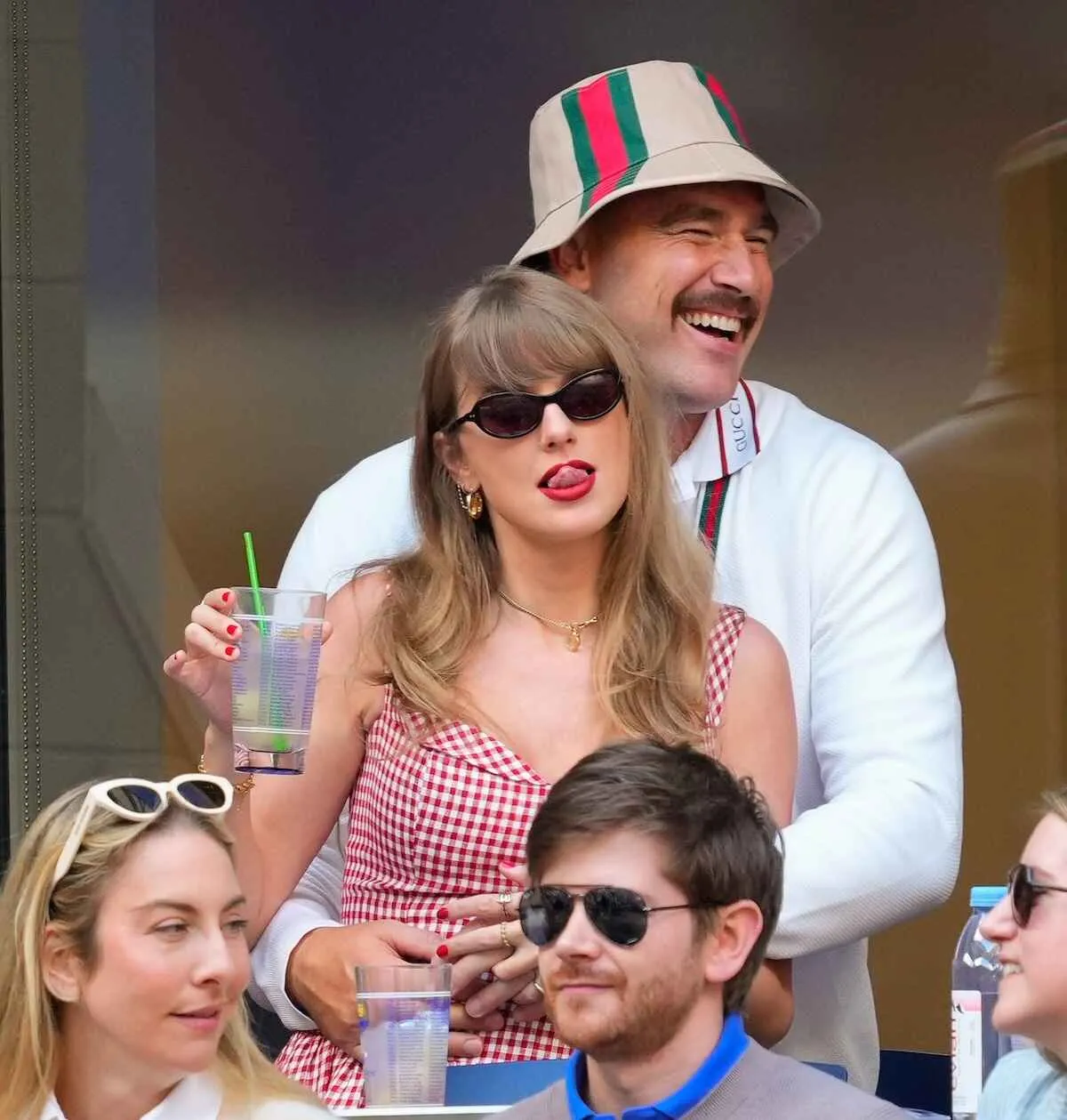 Taylor Swift and Travis Kelce having fun at tennis match