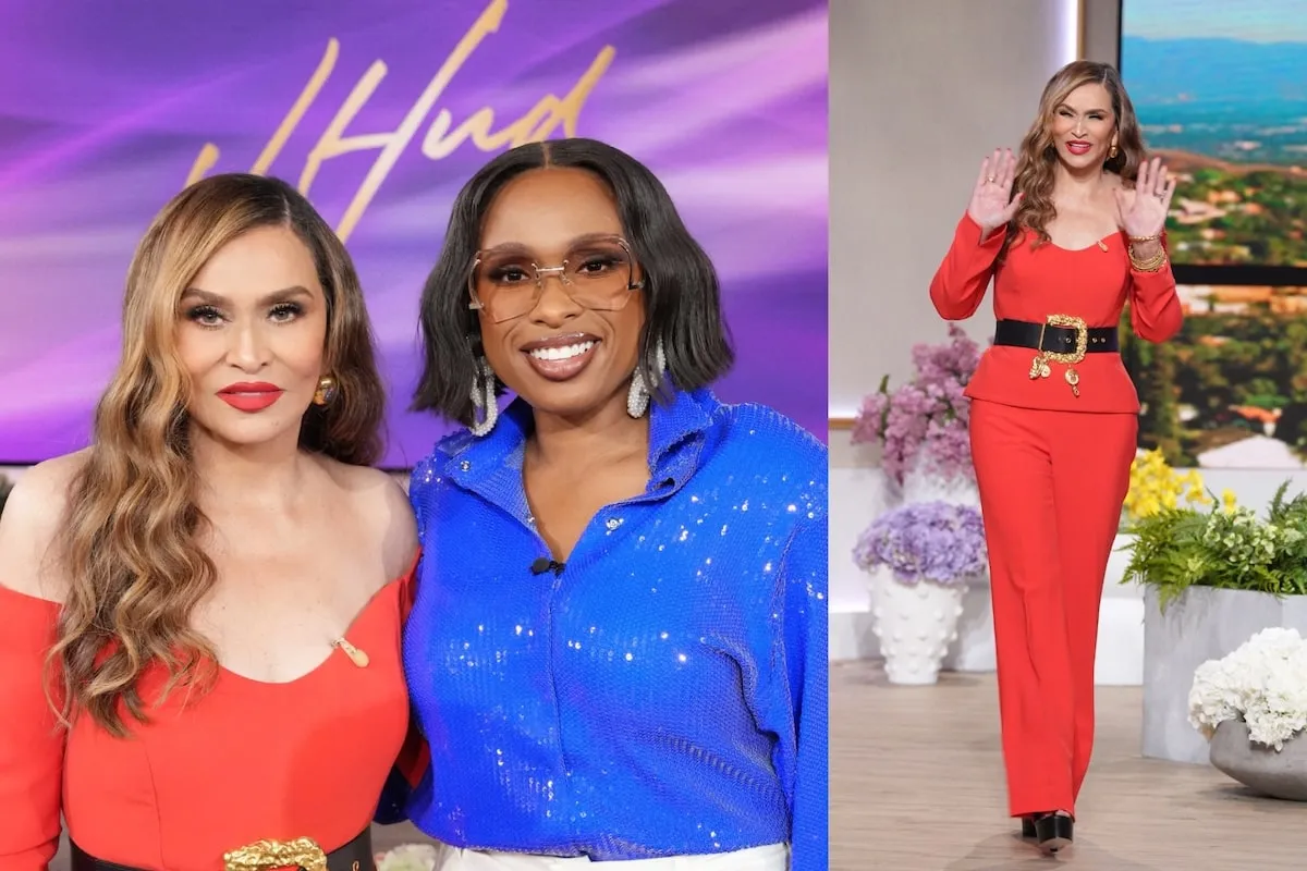 Wearing a red jumpsuit, Tina Knowles waves to viewers on The Jennifer Hudson Show