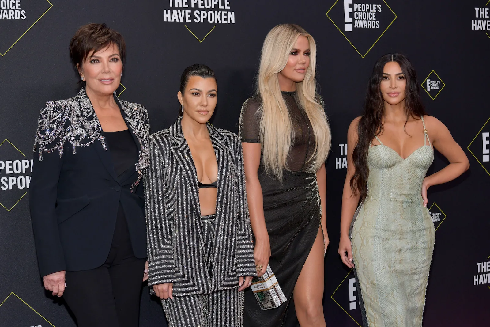 Kris Jenner, Kourtney Kardashian, Khloé Kardashian, and Kim Kardashian posing together at the People's Choice Awards in 2019