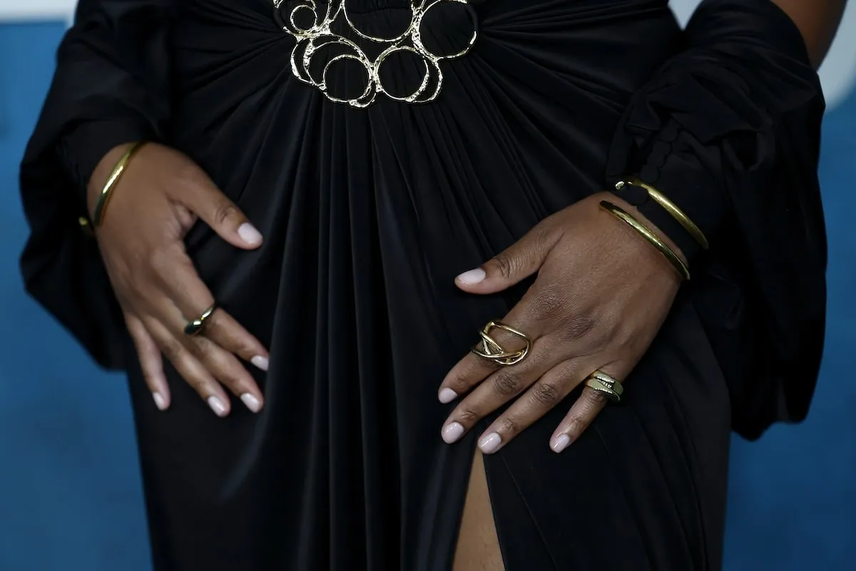 Wearing a black gown with a plunging necklace, Tika Sumper shows off her jewelry while walking the red carpet before the American Black Film Festival