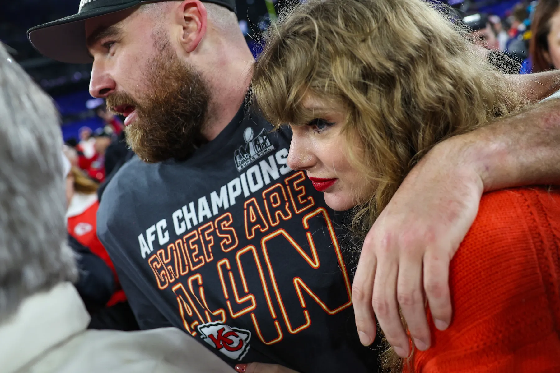 A close-up of the side of Taylor Swift's face as she huge Travis Kelce after a Kansas City Chiefs game