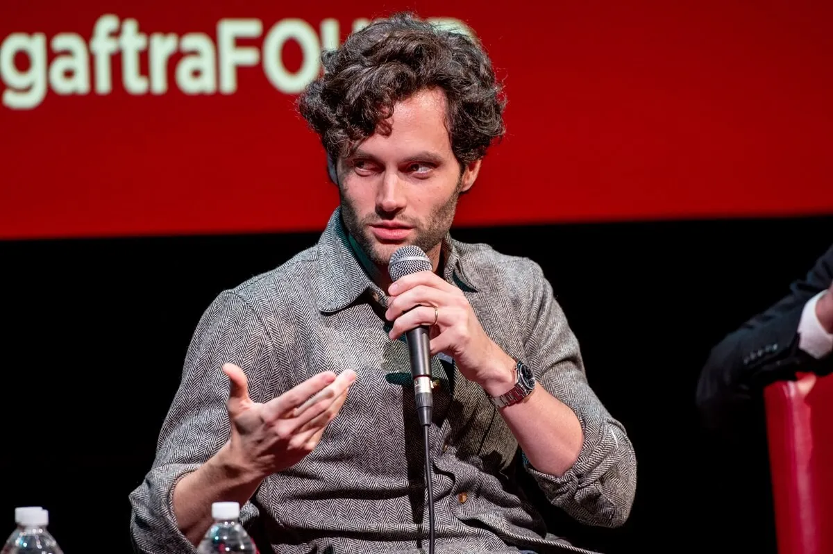 Penn Badgley discusses "You" during SAG-AFTRA Foundation Conversations while wearing a grey shirt.