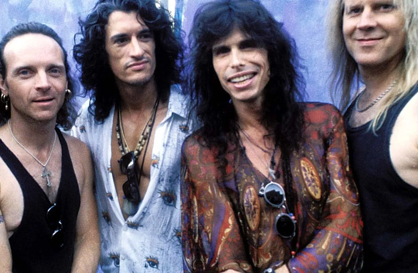 "I Don't Want a Thing" era Aerosmith with a blue backdrop