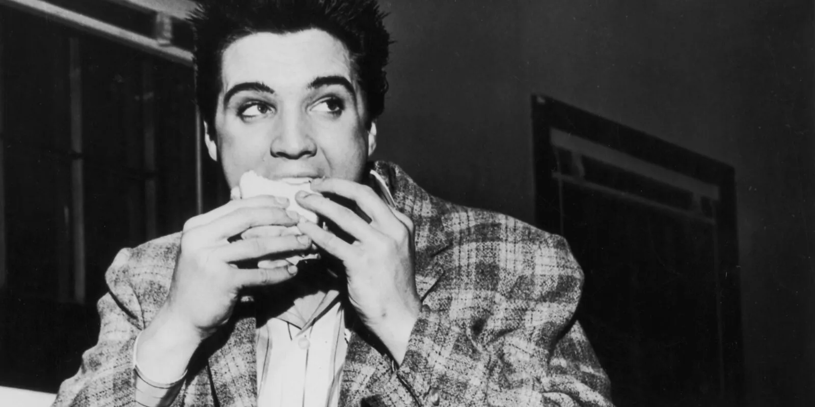 Elvis Presley eats a sandwich in 1958