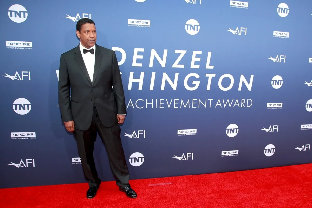 Denzel Washington attends the 47th AFI Life Achievement Award honoring Denzel Washington while posing in a suit.