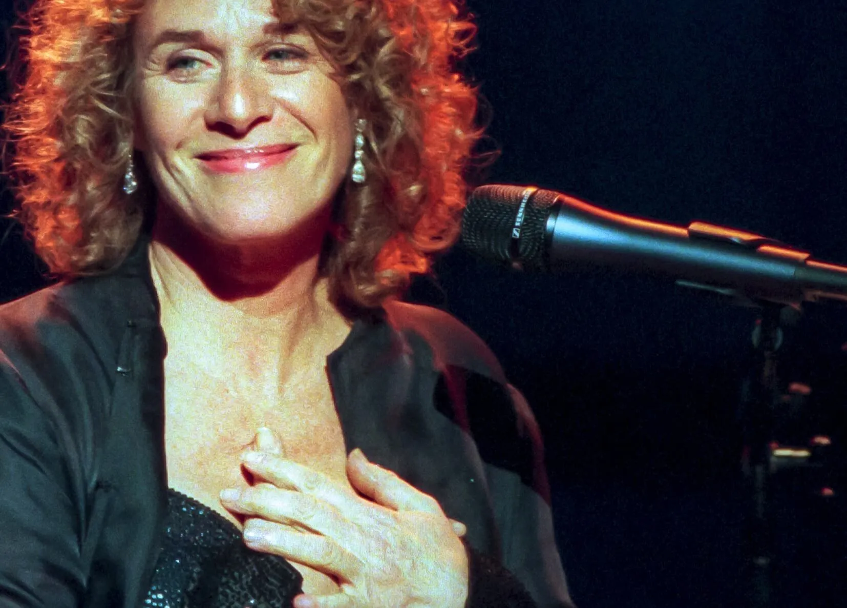 Carole King with a microphone