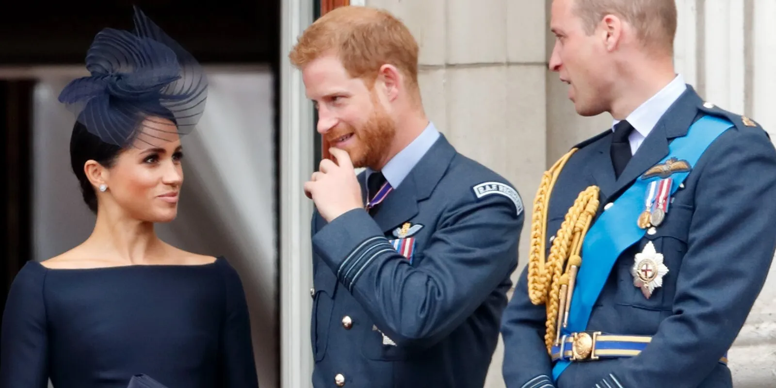 Meghan Markle, Prince Harry and Prince William atch a flypast to mark the centenary of the Royal Air Force from the balcony of Buckingham Palace on July 10, 2018 in London, England.